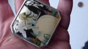 Vintage Art Deco Gwenda Celluloid Foil Miniature Powder Compact. Lid Decorated with an Image of a Pretty Lady in a Garden Setting