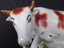 Load image into Gallery viewer, ANTIQUE STAFFORDSHIRE Figurine. Large Cow with her White Calf on Raised Oval Base; 1880s
