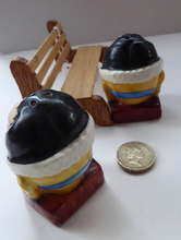 Load image into Gallery viewer, Vintage CRUET SET. Strange Novelty Ceramic Elizabethan Court Figures Sitting on a Wooden Bench
