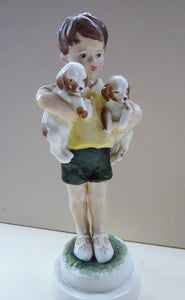 Royal Worcester Figurine. ALL MINE.  Modelled by Freda Doughty. No 3519. Boy Holding Puppies. PRISTINE
