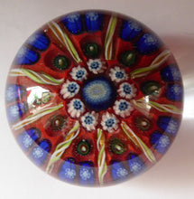 Load image into Gallery viewer, Beautiful VASART Scottish Glass Paperweight with 9 Spokes; with scarlet ground, latticino canes &amp; millefiore. 3 inches diameter
