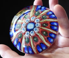 Load image into Gallery viewer, Beautiful VASART Scottish Glass Paperweight with 9 Spokes; with scarlet ground, latticino canes &amp; millefiore. 3 inches diameter
