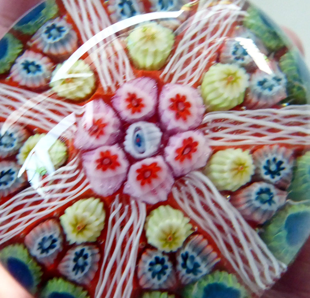 Collectable 1970s Scottish Glass Paperweight with 7 Spokes. Unusual Red Ground and Tutti Frutti Colours