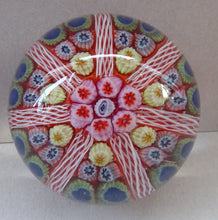 Load image into Gallery viewer, Collectable 1970s Scottish Glass Paperweight with 7 Spokes. Unusual Red Ground and Tutti Frutti Colours
