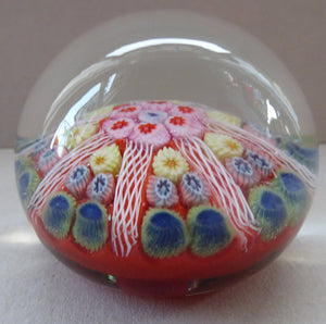 Collectable 1970s Scottish Glass Paperweight with 7 Spokes. Unusual Red Ground and Tutti Frutti Colours
