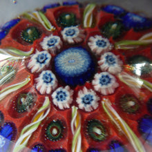 Load image into Gallery viewer, Beautiful VASART Scottish Glass Paperweight with 9 Spokes; with scarlet ground, latticino canes &amp; millefiore. 3 inches diameter
