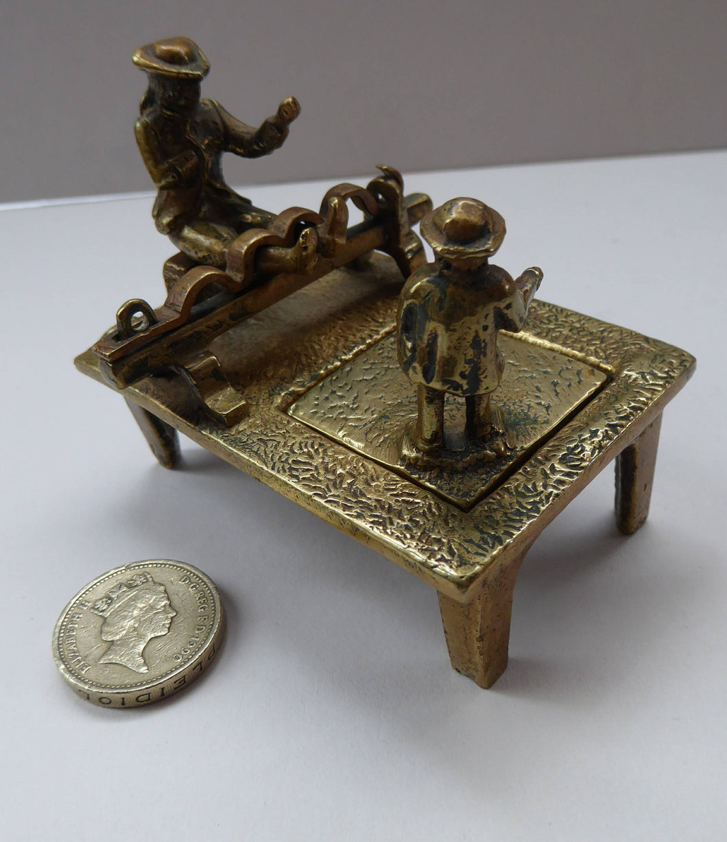 ANTIQUE INKWELL. An Extremely Rare Miniature Example Featuring a Little Man in Village Stocks Being Pelted with Fruit