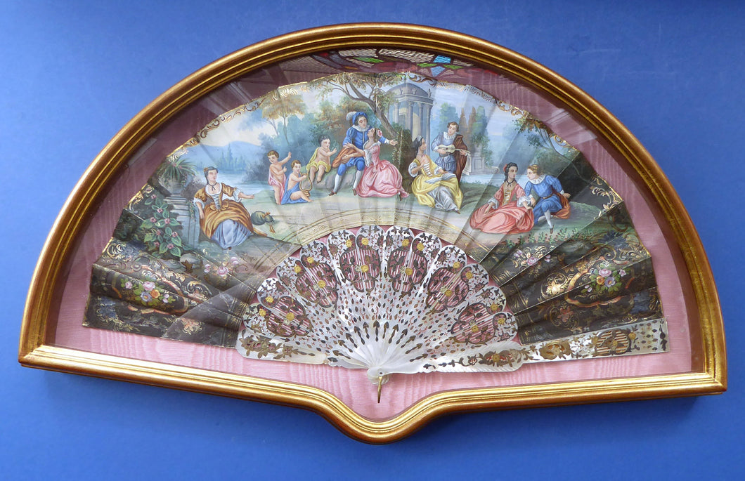 Antique FRAMED Hand Painted Fan with mother of pearl sticks and guards:  shaped, carved, pierced and gilt. FETE GALANTE design