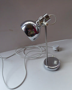 1960s CHROME DESK LAMP with movable shiny chrome shade, and on / off switch on the base. Good Condition