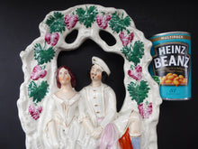 Load image into Gallery viewer, HUGE Antique STAFFORDSHIRE Figurine of a Couple sitting in a bower of fruiting vine; Height 13 1/2 inches
