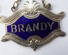 Load image into Gallery viewer, 1930s SILVER PLATE and Royal Blue Guilloche Enamel Brandy Decanter Label
