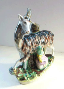 STAFFORDSHIRE POTTERY. Strange Victorian Spill Holder featuring a milkmaid and a massive goat