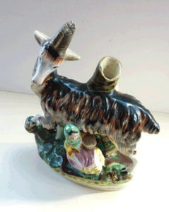 STAFFORDSHIRE POTTERY. Strange Victorian Spill Holder featuring a milkmaid and a massive goat