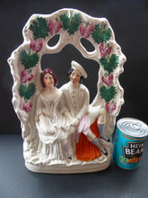 Load image into Gallery viewer, HUGE Antique STAFFORDSHIRE Figurine of a Couple sitting in a bower of fruiting vine; Height 13 1/2 inches
