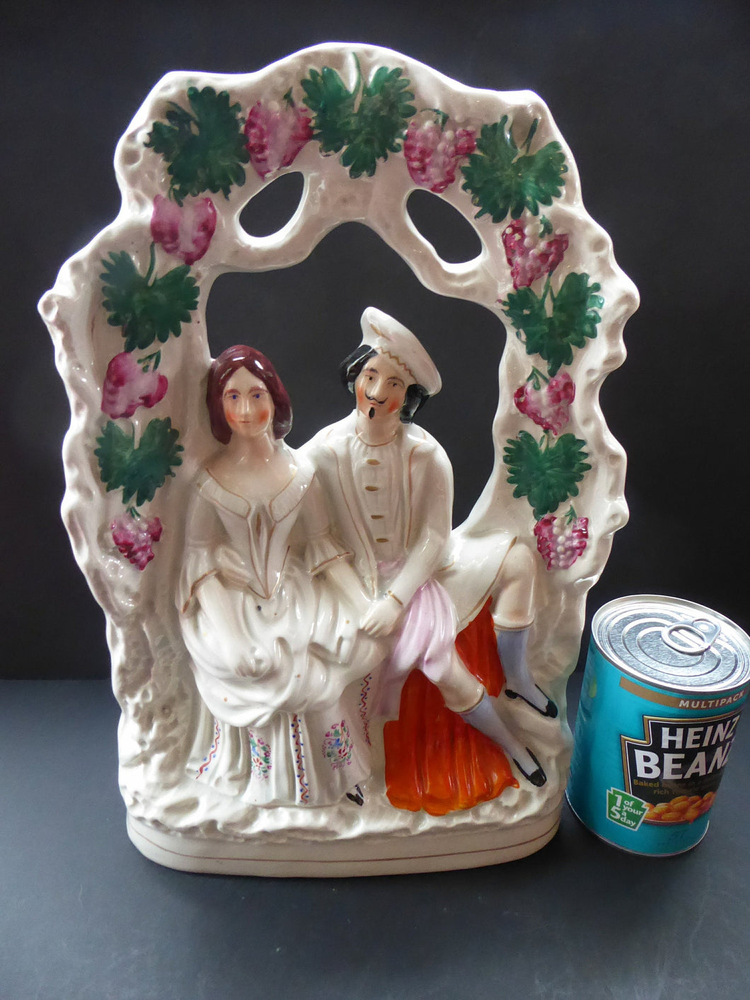 HUGE Antique STAFFORDSHIRE Figurine of a Couple sitting in a bower of fruiting vine; Height 13 1/2 inches