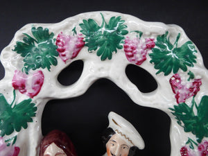 HUGE Antique STAFFORDSHIRE Figurine of a Couple sitting in a bower of fruiting vine; Height 13 1/2 inches
