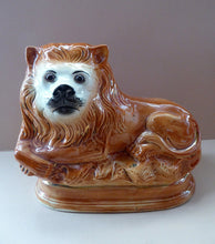 Load image into Gallery viewer, Large ANTIQUE Victorian Staffordshire Recumbent Lion with Glass Eyes. 11 inches in length
