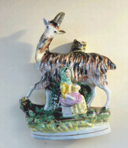 STAFFORDSHIRE POTTERY. Strange Victorian Spill Holder featuring a milkmaid and a massive goat