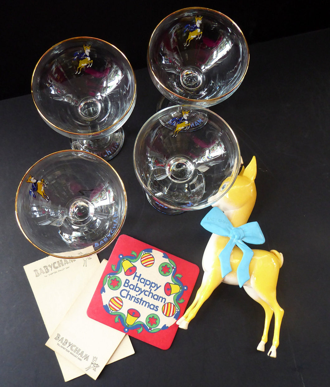 VINTAGE Babycham Job Lot: Large Plastic Babycham Bambi Fawn Model. 7 1/2 inches. Offered with four coupe glasses, Happy Christmas Beer Mat