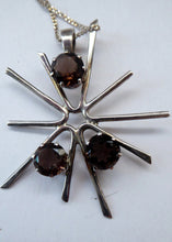 Load image into Gallery viewer, SCOTTISH SILVER 1970s ORTAK Starburst Pendant Necklace. Designed by Malcolm Grey.  Set with Three Smoky Quartz Stones. Hallmarked
