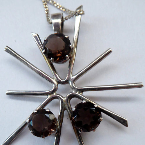 SCOTTISH SILVER. 1970s ORTAK Starburst Pendant Necklace. Designed by Malcolm Grey.  Set with Three Smoky Quartz Stones. Hallmarked