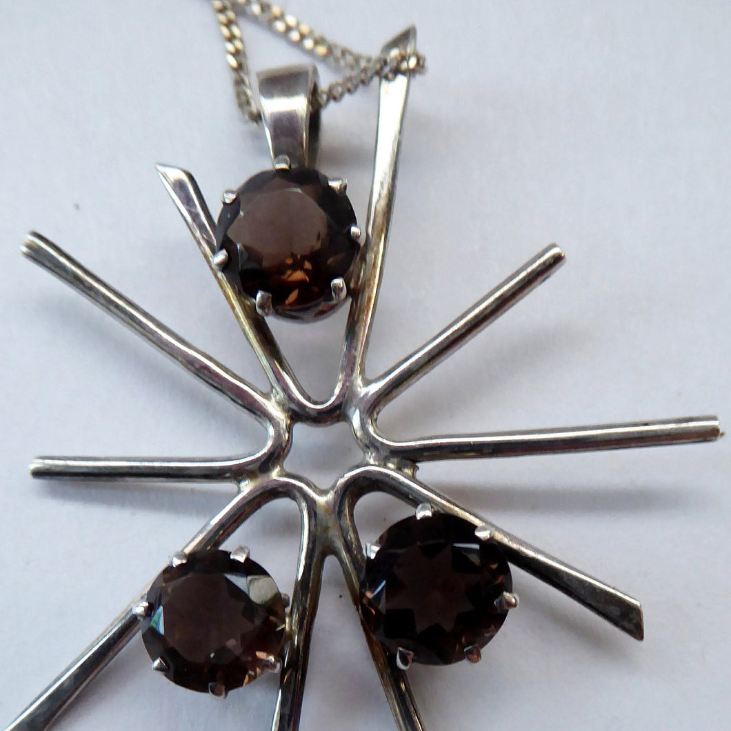 SCOTTISH SILVER. 1970s ORTAK Starburst Pendant Necklace. Designed by Malcolm Grey.  Set with Three Smoky Quartz Stones. Hallmarked