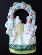 Load image into Gallery viewer, ANTIQUE Victorian Staffordshire Figurine. Small Flatback Model of a Man and Woman at a Water Well
