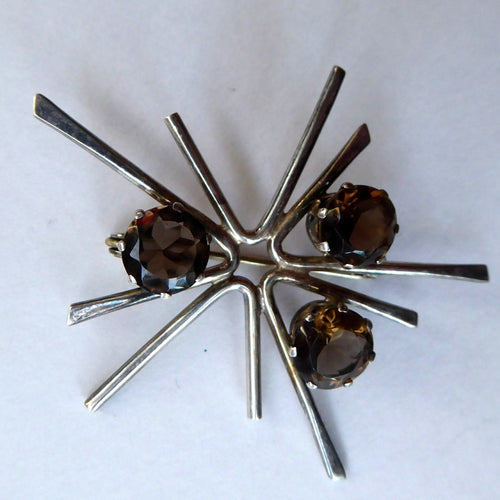SCOTTISH SILVER. 1970s ORTAK Starburst Brooch. Designed by Malcolm Grey.  Set with Three Smoky Quartz Stones. Hallmarked