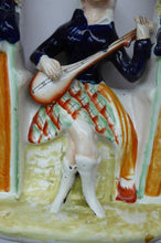 Load image into Gallery viewer, ANTIQUE Victorian Staffordshire Figurine. Lady Dressed in a Short Plaid Skirt Seated Under a Bough Playing a Lute
