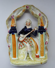 Load image into Gallery viewer, ANTIQUE Victorian Staffordshire Figurine. Lady Dressed in a Short Plaid Skirt Seated Under a Bough Playing a Lute
