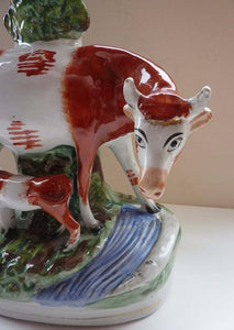 Large Staffordshire Spill Vase / Antique Figurine of a Cow Suckling her Calf by the Side of a River